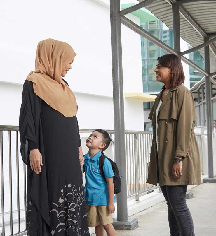teacher speaking to a parent with her child